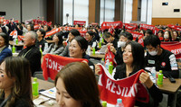 People watch a live broadcast of the launch of an ispace lunar lander in Tokyo on Wednesday.