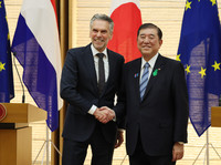 Japanese Prime Minister Shigeru Ishiba (right) and Dutch Prime Minister Dick Schoof smile and shake hands in Tokyo on Monday.