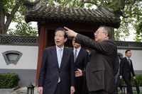 Natsuo Yamaguchi (left), former leader of Japan's junior ruling party Komeito, visits a traditional building in Beijing on Wednesday with Liu Jianchao (right), head of the International Department of the Communist Party of China's Central Committee. (Pool photo)