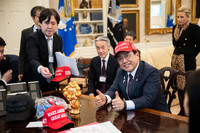 Economic revitalization minister Ryosei Akazawa (right foreground) poses with the gold-colored Myaku-Myaku coin bank on April 16. (Courtesy of the White House)