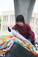 Students from Hiroshima Jogakuin University offer paper cranes at the Children's Peace Monument in Hiroshima on Monday.