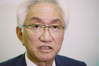 Shoji Nishida, a House of Councillors lawmaker of the ruling Liberal Democratic Party, answers questions from reporters at the Diet building on Wednesday.