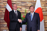 Japanese Prime Minister Shigeru Ishiba (right) and Latvian President Edgars Rinkevics shake hands before a meeting in Tokyo on Monday.
