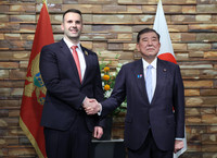 Japanese Prime Minister Shigeru Ishiba (right) and his Montenegro counterpart, Milojko Spajic, shake hands before their meeting at the prime minister's office in Tokyo on Wednesday.
