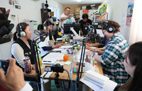 Machino Radio members try out radio broadcasting in the town of Onagawa, Miyagi Prefecture, on May 16.