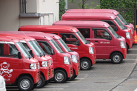 Japan Post's delivery vehicles are lined up at a post office in Tokyo on Sunday.