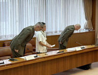 Col. Neil Owens, chief of staff for the 3rd Marine division, (right) apologizes following a recent conviction of a U.S. Marine, at the Okinawa prefectural government office in Naha on Thursday.
