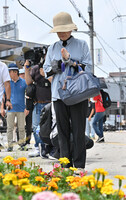 A woman offers a prayer to the late former Japanese Prime Minister Shinzo Abe in the city of Nara on Tuesday, exactly three years after he was shot to death.