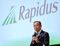Rapidus Corp. President Atsuyoshi Koike holds a press conference in the city of Chitose, Hokkaido, on Friday to announce the successful production of a prototype of advanced semiconductor chips with a circuit line width of 2 nanometers.