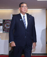 Japanese Prime Minister Shigeru Ishiba, also president of the ruling Liberal Democratic Party, enters the party's headquarters in Tokyo on Wednesday.