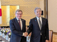 Japanese Foreign Minister Takeshi Iwaya (right) and his German counterpart, Johann Wadephul, shake hands at the Foreign Ministry's Iikura Guest House in Tokyo on Monday.