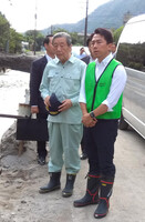 Japanese agriculture minister Shinjiro Koizumi (right) and Hiroshi Moriyama (center), secretary-general of the ruling Liberal Democratic Party, inspect on Monday an irrigation channel heavily damaged by recent heavy rains in the city of Kirishima, Kagoshima Prefecture, southwestern Japan.